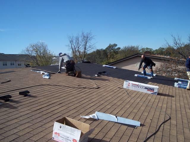 PRO TOP Roofing repairing a brownish aspahalt roof on a residential rooftop