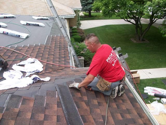 Image of a residential home with asphalt roofing and cloudy blue sky's in the background
